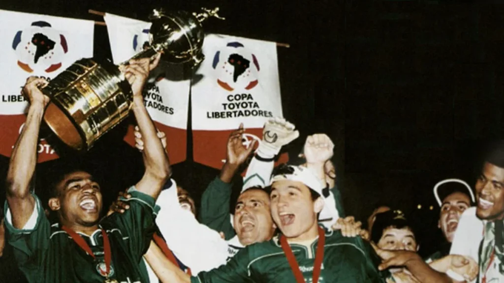 Jogadores do Palmeiras, de camisa verde, levantam a taça da Copa Libertadores de 1999